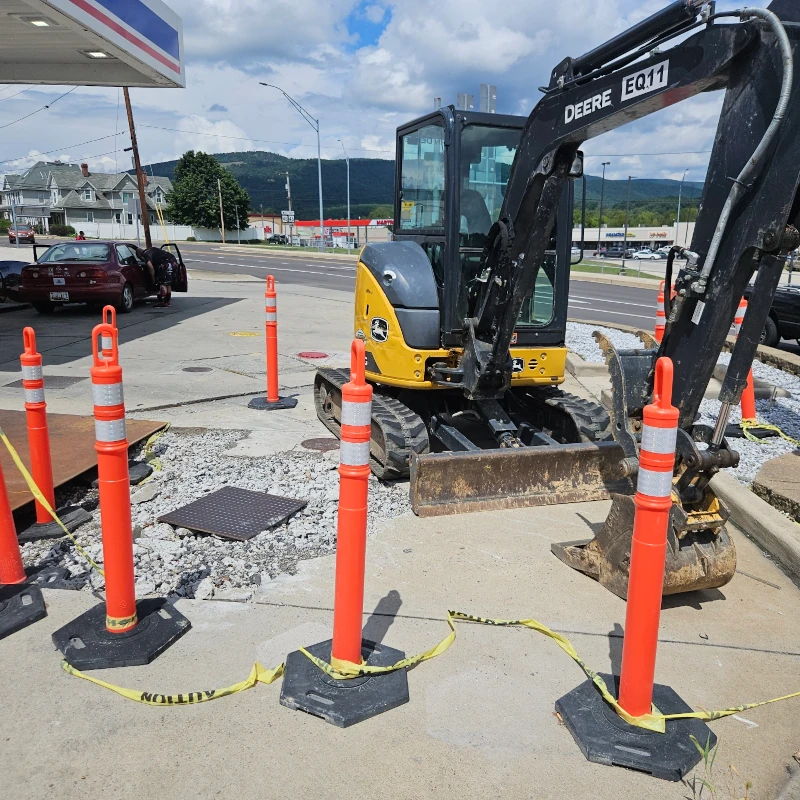 backhoe doing trenching work at a gas station